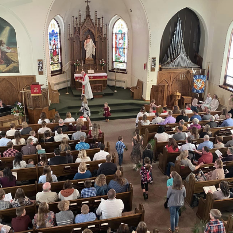 church pews full of attendees during service