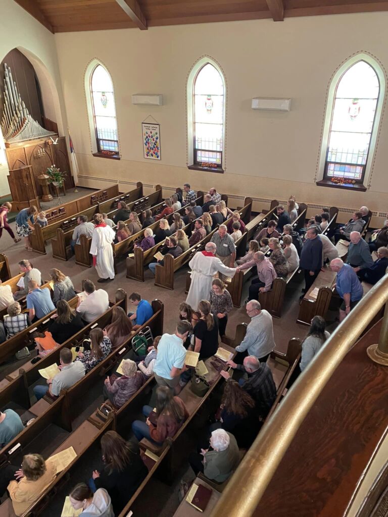 church pews full of attendees during mass